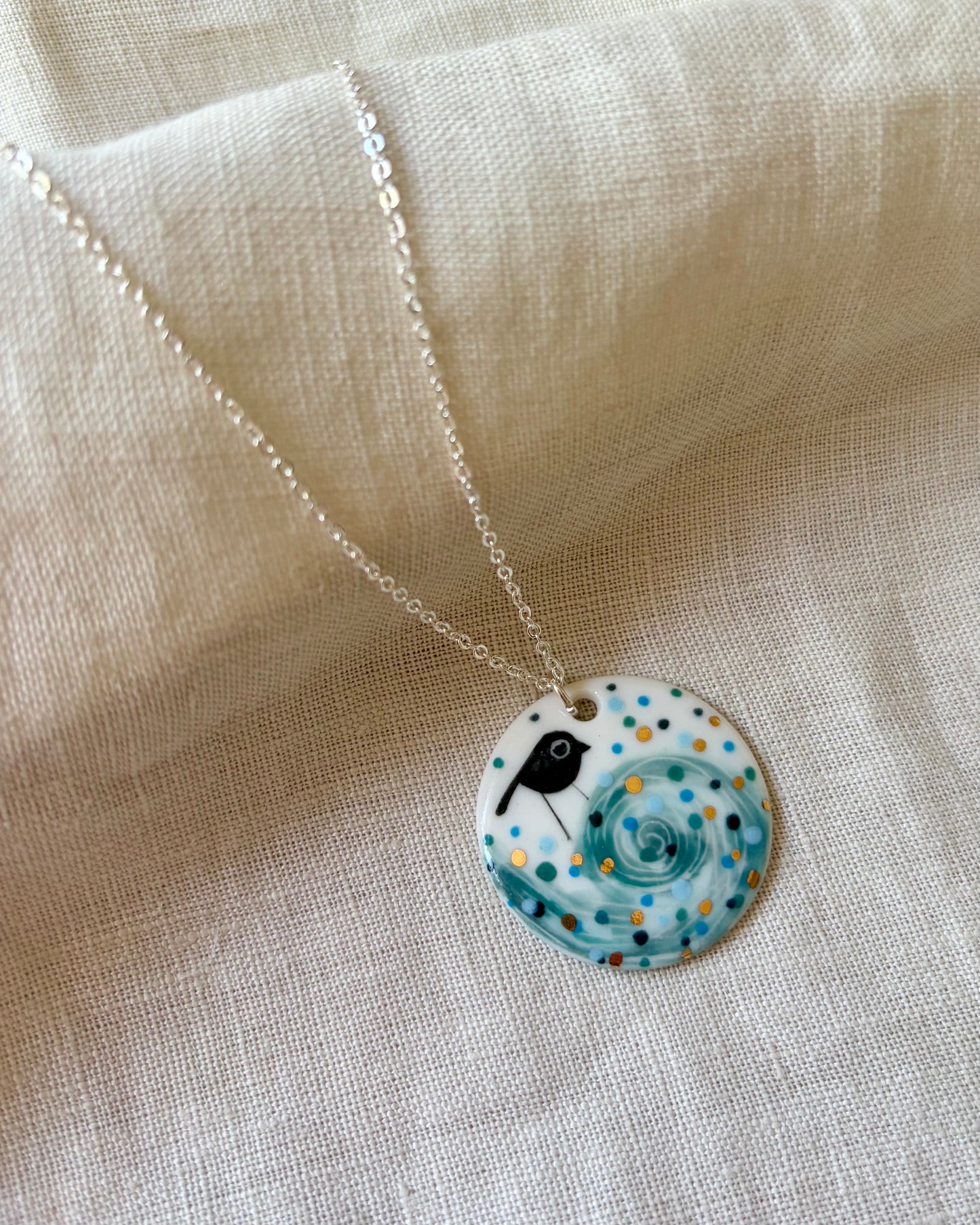 Bird On Swirl Wave Necklace With Gold Lustre