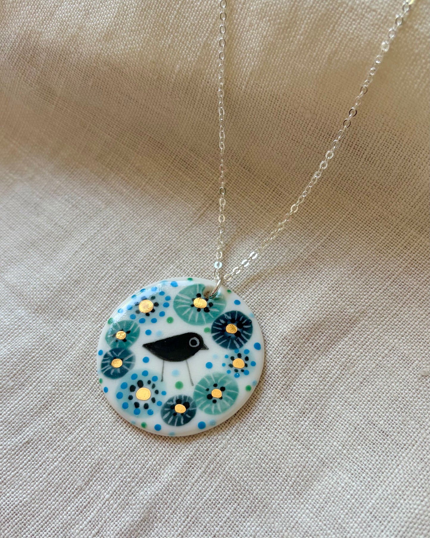 Bird in Blue Flower Necklace With Gold Lustre