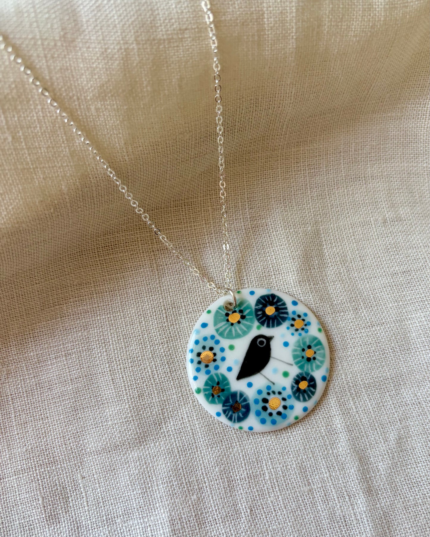 Bird in Blue Flower Necklace With Gold Lustre