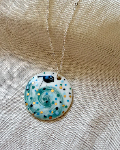 Bird On Swirl Wave Necklace With Gold Lustre